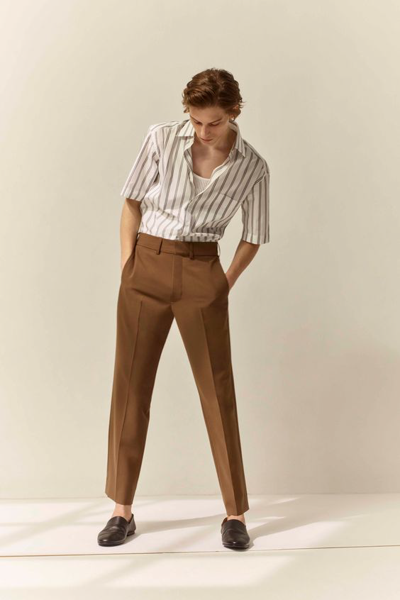 Stylish man in brown trousers and striped shirt